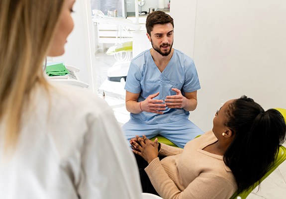 Dentist explaining tooth extraction to a patient 